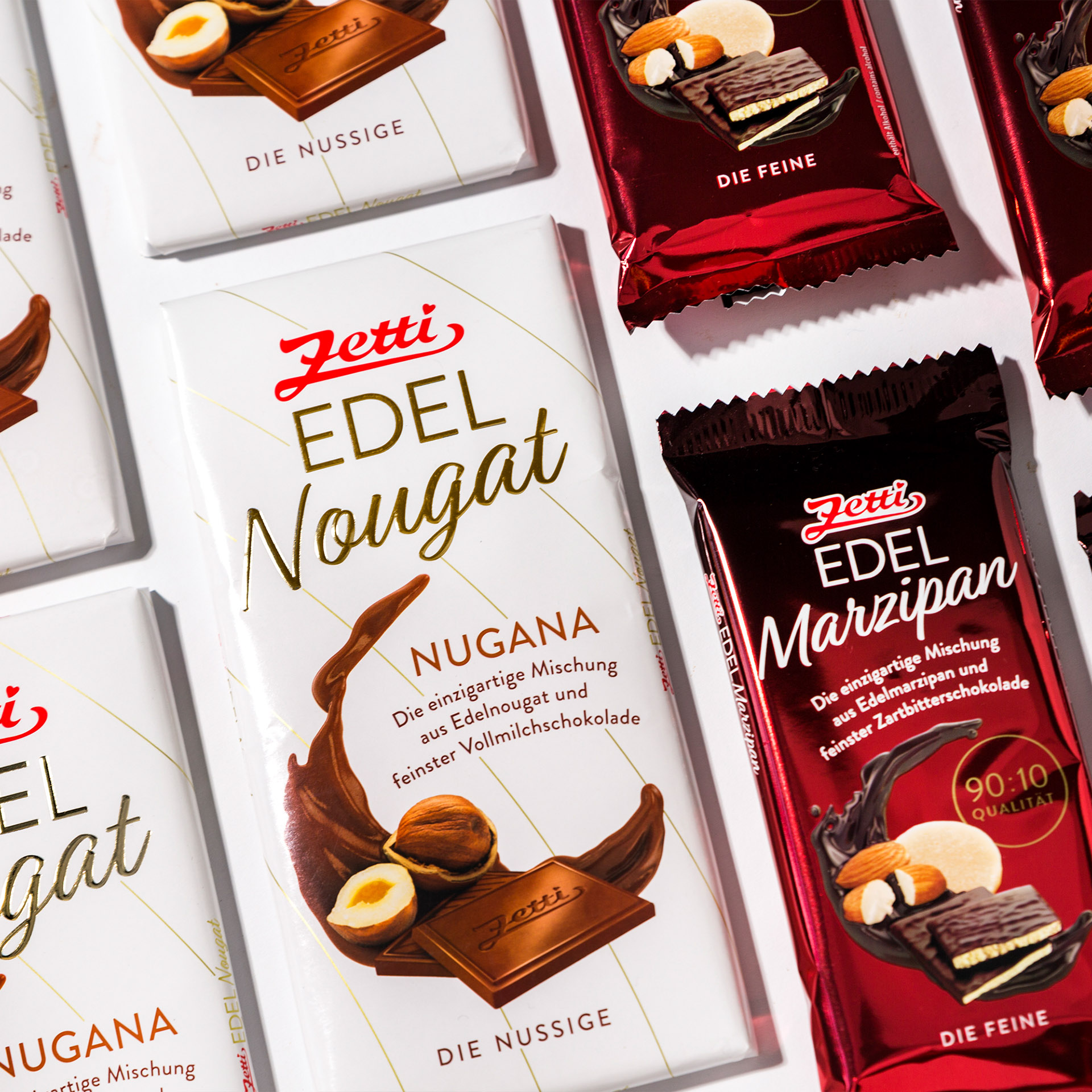 Eine Abbildung aneinander gereihter Tafeln Zetti Edel Marzipan und Edel Nougat